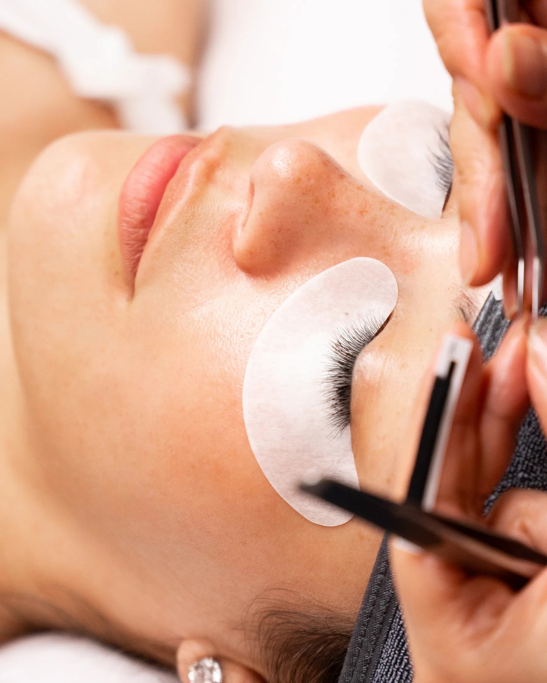 A lash artist performing a precision lash service at Stacy Lash & Skin